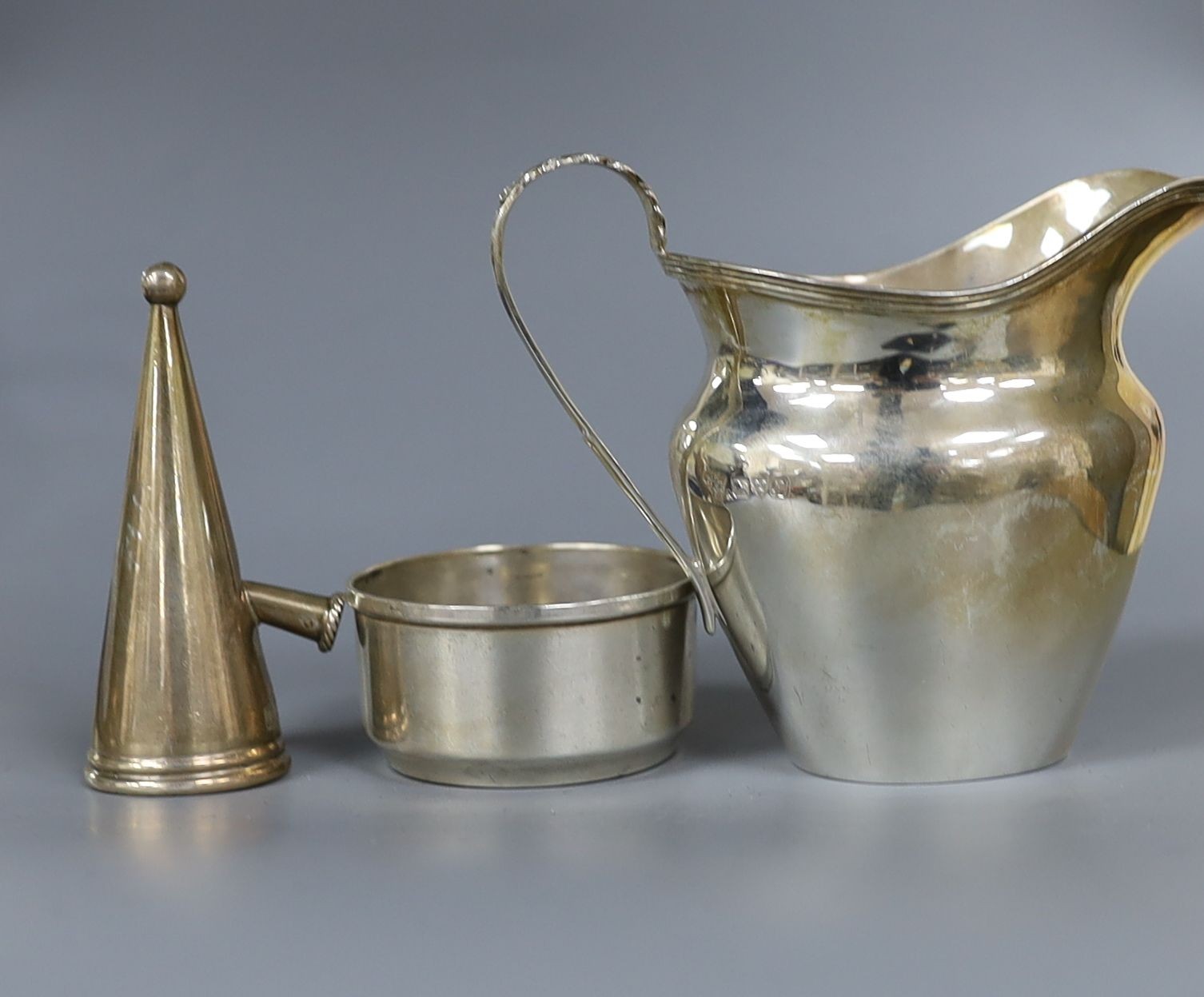 An American sterling sauceboat, a silver cream jug, a modern silver commemorative letter opener and three other items.